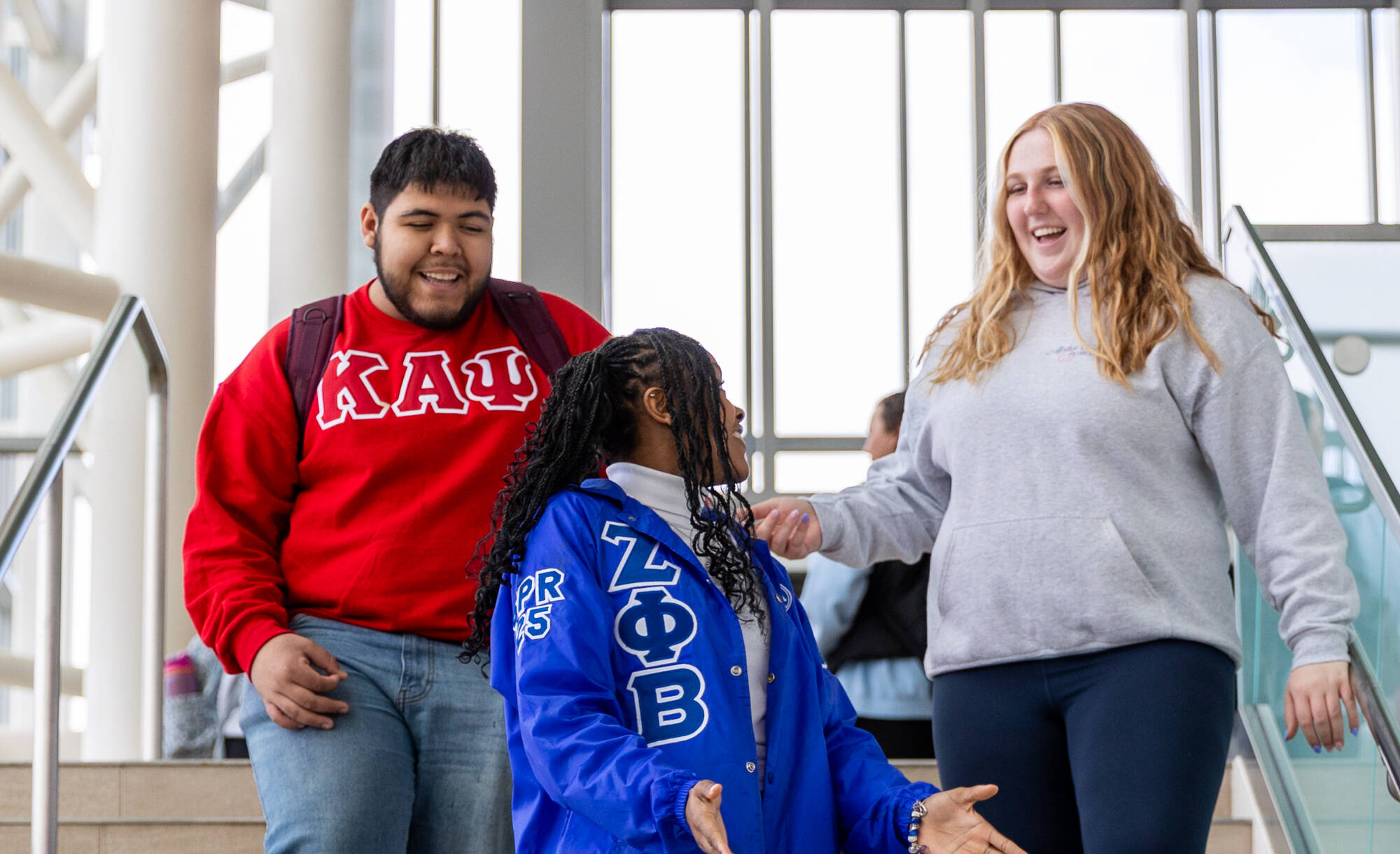 Greek affiliated students walking down the library stairs